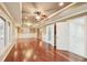 Living room featuring hardwood floors, neutral paint, and a bathroom, window and door at 6030 Chimney Springs Rd, Buford, GA 30518