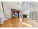 Open living room with hardwood floors, stone fireplace, and large windows offering ample natural light at 6030 Chimney Springs Rd, Buford, GA 30518