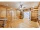 Wood-paneled living room with built-in shelves, wood floors and view of the staircase at 6030 Chimney Springs Rd, Buford, GA 30518