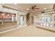 Open living room with a bar, staircase, and access to the outside with neutral walls and flooring at 6030 Chimney Springs Rd, Buford, GA 30518