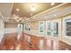 Spacious living room featuring hardwood floors, neutral paint, and easy access to the back patio at 6030 Chimney Springs Rd, Buford, GA 30518