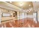 Large living room with hardwood floors, neutral walls, and easy access to a kitchen and the outdoors at 6030 Chimney Springs Rd, Buford, GA 30518