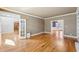 An open living room with hardwood floors, white trim, and ample space for both seating and showcasing personal decor at 6030 Chimney Springs Rd, Buford, GA 30518