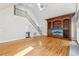 Bright living room featuring a vaulted ceiling, hardwood floors, and custom built-in shelving at 6030 Chimney Springs Rd, Buford, GA 30518