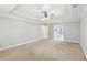 Large main bedroom offers neutral walls, plush carpet, and a view to the bathroom at 6030 Chimney Springs Rd, Buford, GA 30518