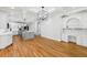Spacious open area with hardwood floors connecting the kitchen and office, perfect for modern living at 6030 Chimney Springs Rd, Buford, GA 30518