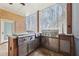 Gourmet outdoor kitchen with stainless steel appliances and covered patio overlooking the backyard at 6030 Chimney Springs Rd, Buford, GA 30518