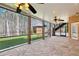 Open-air screened patio offering ample space with stone floors, a fan, and serene wooded views at 6030 Chimney Springs Rd, Buford, GA 30518