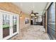 Spacious outdoor patio with stone flooring and ceiling fans, perfect for entertaining or relaxing at 6030 Chimney Springs Rd, Buford, GA 30518