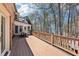 A spacious rear deck offers a serene view of the surrounding trees and a glimpse of the lake at 6030 Chimney Springs Rd, Buford, GA 30518