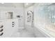 Walk-in shower with multiple shower heads, bench, and window overlooking outdoor scenery at 6030 Chimney Springs Rd, Buford, GA 30518
