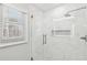 Beautiful tiled shower featuring a glass enclosure, rainfall shower head, and a tiled inset at 6030 Chimney Springs Rd, Buford, GA 30518