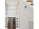 Custom wine storage under staircase featuring wine refrigerator and tile backsplash at 6030 Chimney Springs Rd, Buford, GA 30518