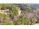An aerial view displays a beautiful lot surrounded by lush trees at 150 Hillred Dr, Fayetteville, GA 30215
