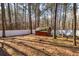 A backyard featuring mature trees, a white fence and a shed at 150 Hillred Dr, Fayetteville, GA 30215