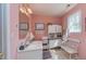 Pink bathroom featuring double sinks, a large mirror, and a vanity area at 150 Hillred Dr, Fayetteville, GA 30215