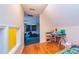 Spacious bonus room with hardwood floors, perfect for creative activities and showcasing the window into the playroom at 150 Hillred Dr, Fayetteville, GA 30215