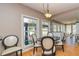 Sunlit breakfast nook with wood floors, complemented by an elegant table and chair set at 150 Hillred Dr, Fayetteville, GA 30215