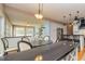 Bright dining area featuring a large table, modern chairs, and stylish pendant lighting at 150 Hillred Dr, Fayetteville, GA 30215