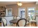 Comfortable dining area with a wooden table, upholstered chairs, and natural light from windows at 150 Hillred Dr, Fayetteville, GA 30215