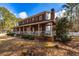Brick home with a huge wrap around porch and white railings, offering a serene outdoor space at 150 Hillred Dr, Fayetteville, GA 30215