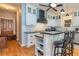 Modern kitchen with white cabinetry, black countertops, stainless steel appliances, and a breakfast bar at 150 Hillred Dr, Fayetteville, GA 30215