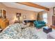 Comfortable living room featuring hardwood floors, exposed beam, and a brick fireplace, perfect for relaxing evenings at 150 Hillred Dr, Fayetteville, GA 30215