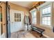 Mudroom features a bench, two windows, a door to the exterior, and hardwood floors at 150 Hillred Dr, Fayetteville, GA 30215