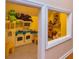 View of the playroom reveals built-in shelf, a playful toy kitchen, and bright, cheerful colors at 150 Hillred Dr, Fayetteville, GA 30215