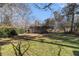 Large backyard with lush lawn and mature trees offering plenty of space for outdoor activities at 2100 Shady Ln, Tucker, GA 30084