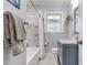 Bathroom featuring a shower/tub combo with marble tile surround and a gray vanity at 2100 Shady Ln, Tucker, GA 30084