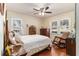Bright bedroom featuring hardwood floors, two windows, and a ceiling fan at 2100 Shady Ln, Tucker, GA 30084