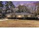 Charming single-story home with brick accents and a welcoming front porch, bathed in the warm glow of sunset at 2100 Shady Ln, Tucker, GA 30084