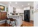 Bright kitchen featuring white cabinets, stainless steel appliances, and a granite-topped breakfast bar at 2100 Shady Ln, Tucker, GA 30084