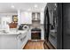 Modern kitchen with stainless steel appliances, white cabinets, and stylish backsplash at 2100 Shady Ln, Tucker, GA 30084