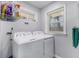 Laundry room with washer, dryer, and overhead storage at 2100 Shady Ln, Tucker, GA 30084