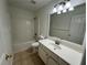 Bright bathroom with a single vanity and tiled floors at 2979 Belfaire Crest Ct, Dacula, GA 30019