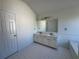 Bathroom featuring double sinks, tub and separate toilet room at 2979 Belfaire Crest Ct, Dacula, GA 30019