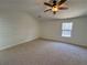 Bedroom with neutral carpet, a ceiling fan and natural light from a large window at 2979 Belfaire Crest Ct, Dacula, GA 30019