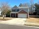 This two-story home features a well-maintained lawn, attached garage, and classic architectural details at 2979 Belfaire Crest Ct, Dacula, GA 30019