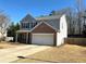 Charming two-story home features a brick-accented facade, attached garage, and inviting front yard at 2979 Belfaire Crest Ct, Dacula, GA 30019