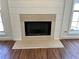 Close-up of the fireplace with a stone hearth and shiplap surround at 2979 Belfaire Crest Ct, Dacula, GA 30019
