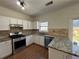 Bright kitchen featuring granite countertops, stainless steel appliances, and a tile backsplash at 2979 Belfaire Crest Ct, Dacula, GA 30019