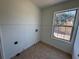 Tiled laundry room with window offering natural light at 2979 Belfaire Crest Ct, Dacula, GA 30019