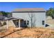 Back exterior view of the house showing the siding, windows, and covered patio area at 50 Crabapple Ridge Dr, Oxford, GA 30054
