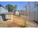 Side view of house showing covered patio and the large, tree-lined backyard at 50 Crabapple Ridge Dr, Oxford, GA 30054