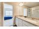 Bright bathroom featuring a double vanity with granite countertops and a view to the bedroom at 50 Crabapple Ridge Dr, Oxford, GA 30054