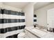 Bathroom with granite countertop, large mirror, and a stylish black and white shower curtain at 50 Crabapple Ridge Dr, Oxford, GA 30054