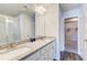 Bathroom featuring double sink vanity with granite counters and a view to the walk-in shower and closet at 50 Crabapple Ridge Dr, Oxford, GA 30054