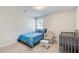 Well-lit bedroom featuring a cozy bed, charming rocking chair, and stylish crib at 50 Crabapple Ridge Dr, Oxford, GA 30054